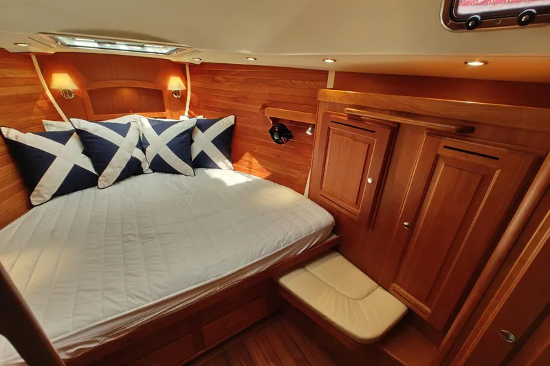 Bella Yacht Photos Pics Luxurious cabin interior of 2018 Tartan 4300 yacht with wood paneling and cozy bedding.