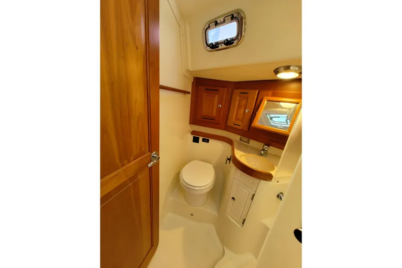 Bella Yacht Photos Pics 2018 Tartan 4300 yacht bathroom with wooden cabinetry and compact design.
