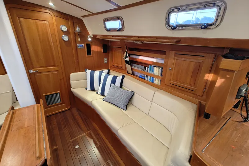 Bella Yacht Photos Pics Luxurious interior of 2018 Tartan 4300 yacht with wooden finish and cozy seating.