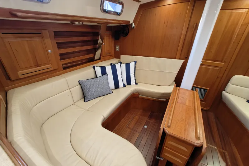 Bella Yacht Photos Pics Luxurious interior of 2018 Tartan 4300 yacht with elegant wood finish and plush seating.