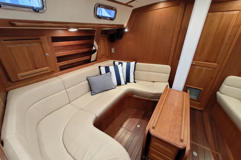 Bella Yacht Photos Pics Luxurious interior of 2018 Tartan 4300 yacht with elegant wood finish and plush seating.