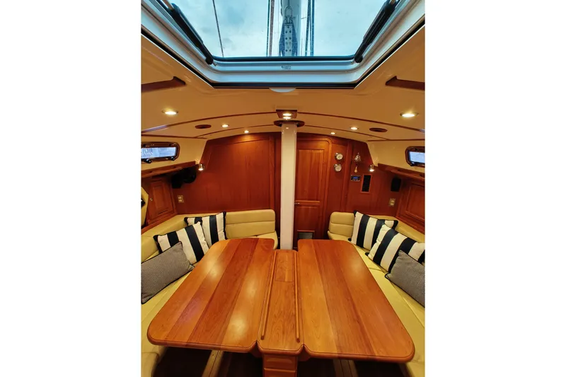 Bella Yacht Photos Pics Luxurious interior of 2018 Tartan 4300 yacht with wooden table and plush seating.