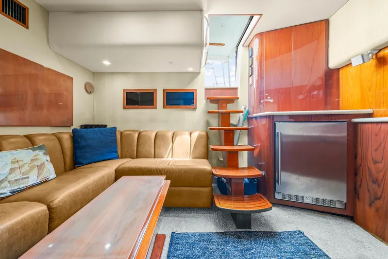 Pale Horse Yacht Photos Pics Luxurious interior of 2006 Buddy Davis 48 Express yacht with plush seating and wooden accents.