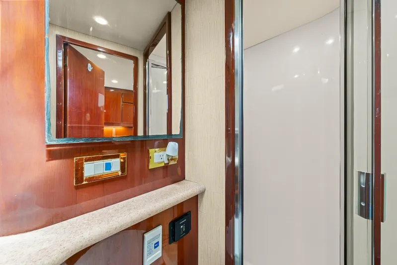 Pale Horse Yacht Photos Pics Interior of 2006 Buddy Davis 48 Express yacht, featuring a mirror and wooden cabinetry.