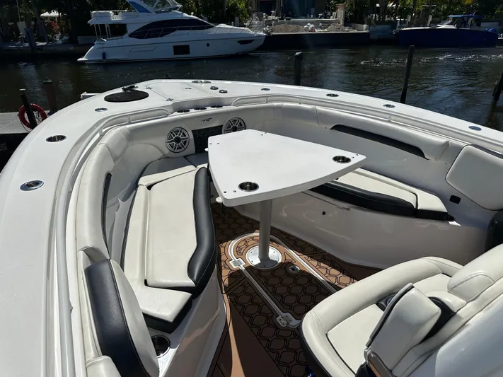  Yacht Photos Pics 2022 Tidewater 280 CC boat interior with seating and table, docked by the water.