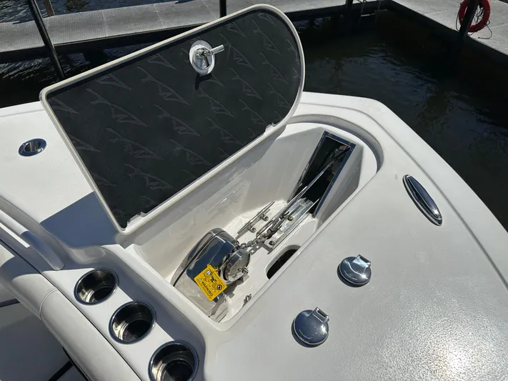 Yacht Photos Pics 2022 Tidewater 280 CC boat anchor compartment with open hatch and cup holders.