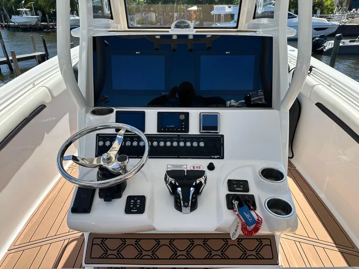  Yacht Photos Pics 2022 Tidewater 280 CC boat console with steering wheel and controls.