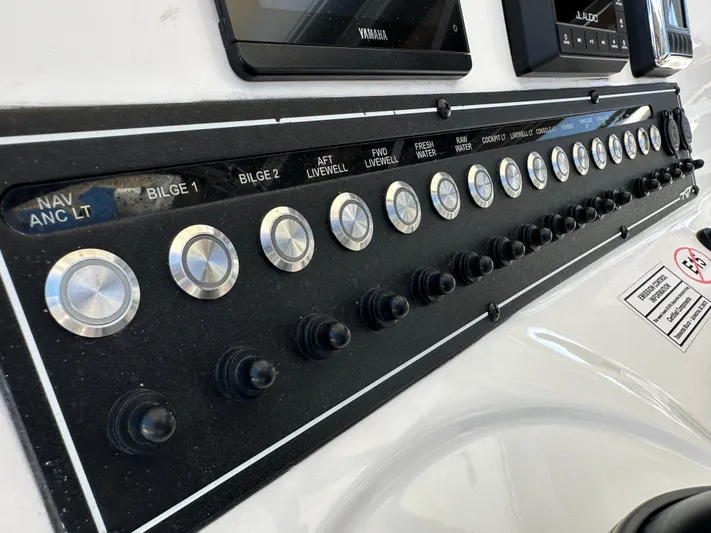  Yacht Photos Pics Control panel of 2022 Tidewater 280 CC boat with labeled switches and buttons.