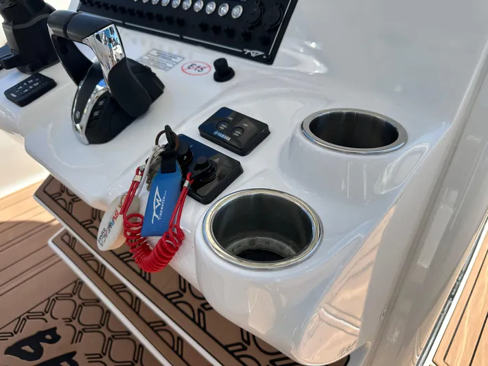  Yacht Photos Pics Control panel of 2022 Tidewater 280 CC boat with cup holders and keys.