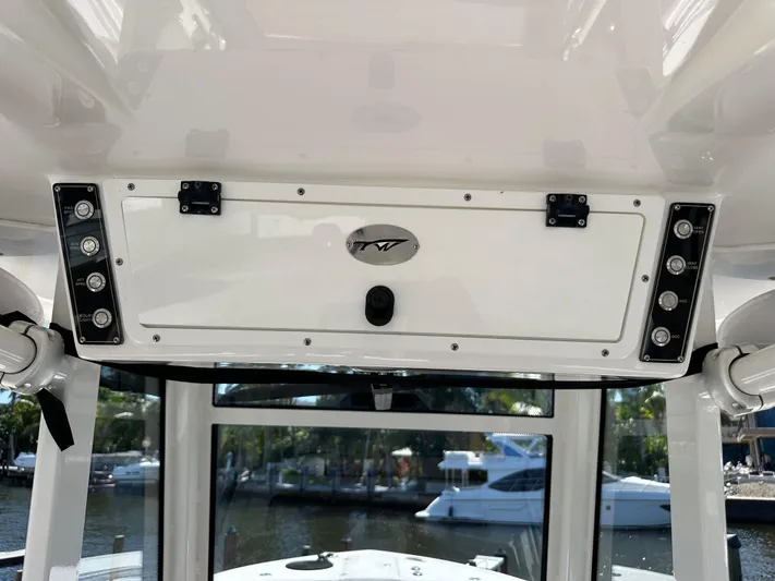  Yacht Photos Pics 2022 Tidewater 280 CC boat console with storage compartment and control panel.