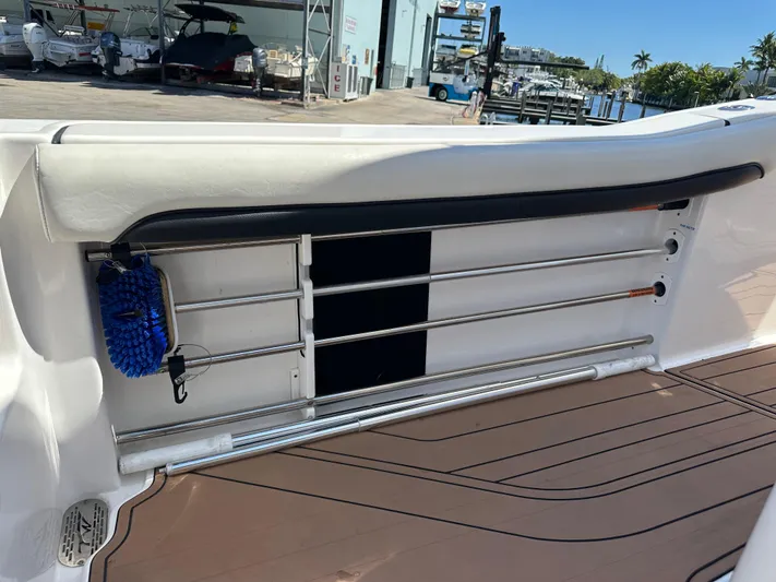  Yacht Photos Pics 2022 Tidewater 280 CC boat interior with rod holders and cleaning brush.