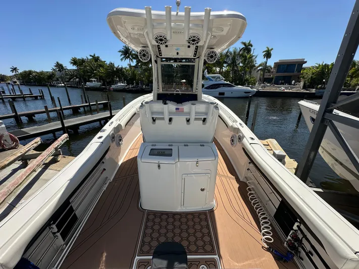  Yacht Photos Pics 2022 Tidewater 280 CC boat docked, featuring spacious deck and modern amenities.