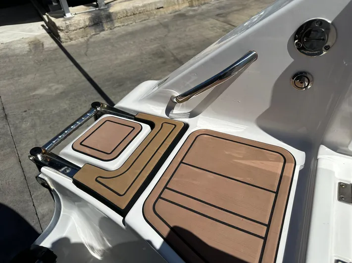  Yacht Photos Pics 2022 Tidewater 280 CC boat deck with non-slip surface and stainless steel handrail.