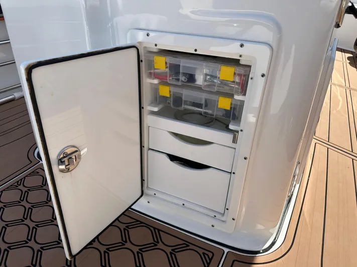  Yacht Photos Pics Open storage compartment on 2022 Tidewater 280 CC boat deck.