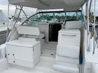 Pathological Yacht Photos Pics 2000 Pursuit 3400 Express boat interior with seating and helm, docked at marina.