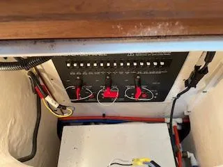 Pathological Yacht Photos Pics Electrical panel inside a 2000 Pursuit 3400 Express boat, featuring switches and wiring.