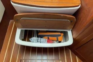 Pathological Yacht Photos Pics Storage compartment in 2000 Pursuit 3400 Express boat with wooden interior.