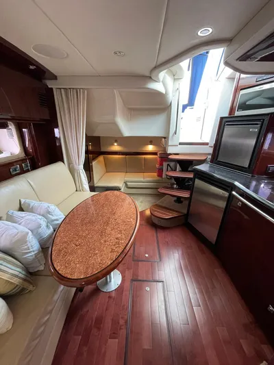 Konichiwa Yacht Photos Pics Interior of 2010 Sea Ray 390 Sundancer yacht with modern kitchen and cozy seating area.