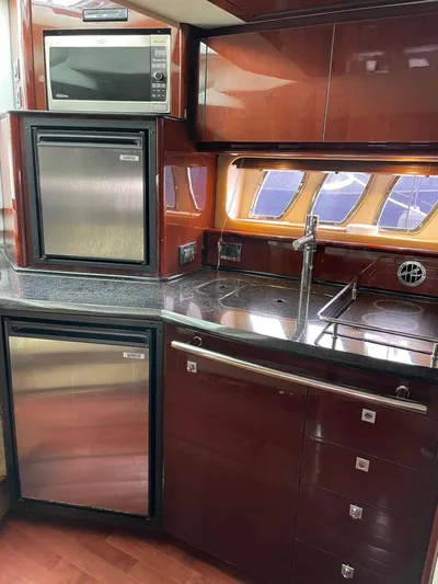 Konichiwa Yacht Photos Pics 2010 Sea Ray 390 Sundancer yacht kitchen with stainless steel appliances and wood cabinetry.