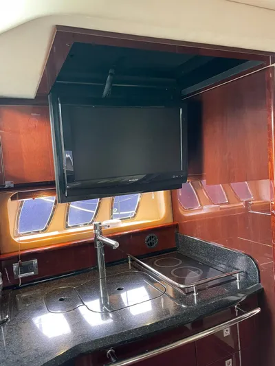 Konichiwa Yacht Photos Pics 2010 Sea Ray 390 Sundancer kitchen with TV, sink, and stove.