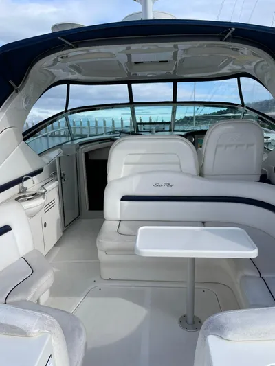 Konichiwa Yacht Photos Pics 2010 Sea Ray 390 Sundancer interior with white seating and table.