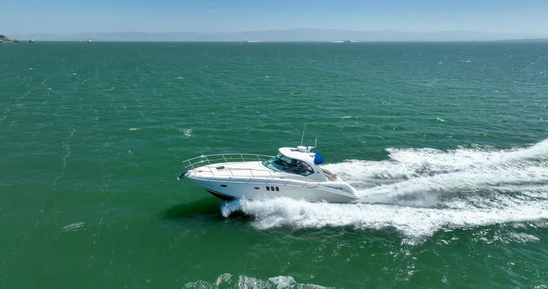 Konichiwa Yacht Photos Pics Sea Ray 390 Sundancer 2010 cruising on open water, creating a wake.