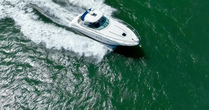 Konichiwa Yacht Photos Pics Sea Ray 390 Sundancer 2010 cruising on open water, aerial view.