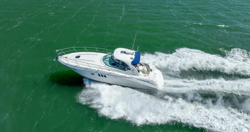 Konichiwa Yacht Photos Pics Sea Ray 390 Sundancer 2010 cruising on open water, creating white waves.