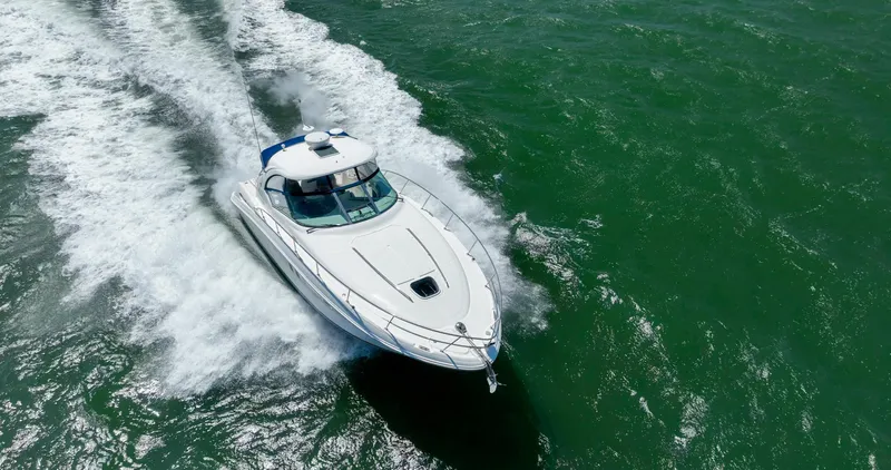 Konichiwa Yacht Photos Pics Sea Ray 390 Sundancer 2010 cruising on open water, aerial view.