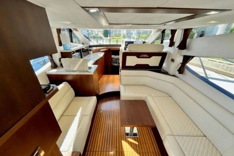  Yacht Photos Pics Luxurious interior of 2017 Galeon 380 Fly yacht with elegant seating and wooden flooring.