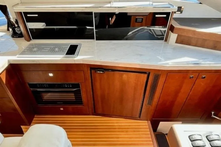  Yacht Photos Pics Luxurious kitchen area in 2017 Galeon 380 Fly yacht with modern appliances and wood finish.