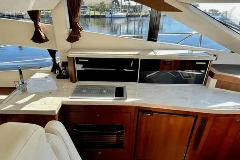  Yacht Photos Pics Luxurious interior of 2017 Galeon 380 Fly yacht with modern kitchen and scenic window view.