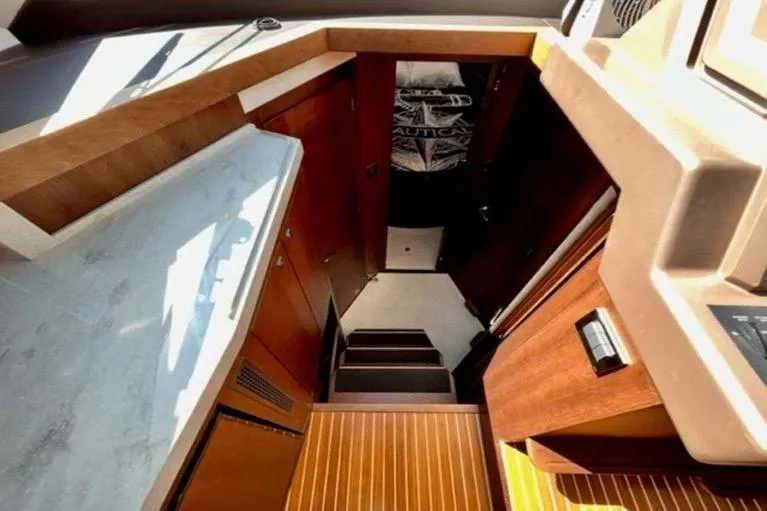  Yacht Photos Pics Interior view of 2017 Galeon 380 Fly yacht with wooden finishes and stairs.