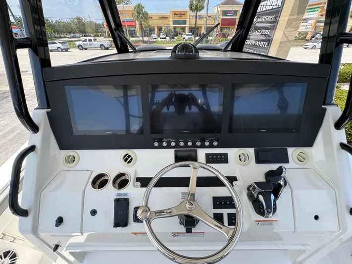 41-090 Yacht Photos Pics 2024 Regulator 41 boat dashboard with steering wheel and digital displays.