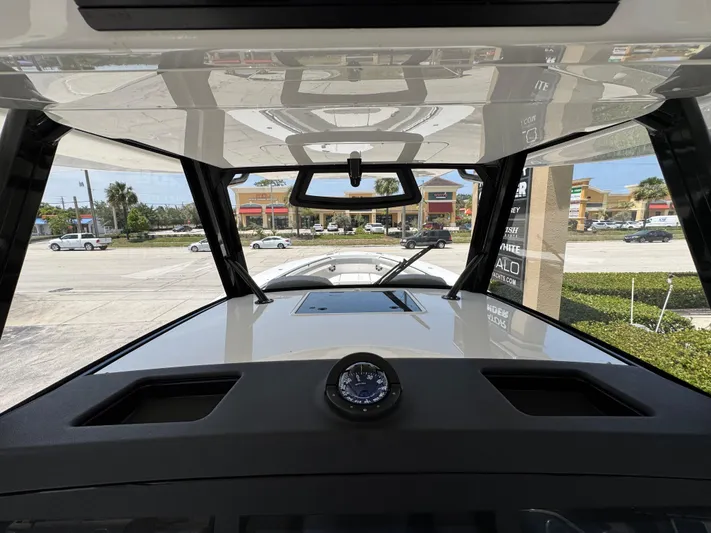 41-090 Yacht Photos Pics 2024 Regulator 41 boat dashboard view with compass, parked near shops.