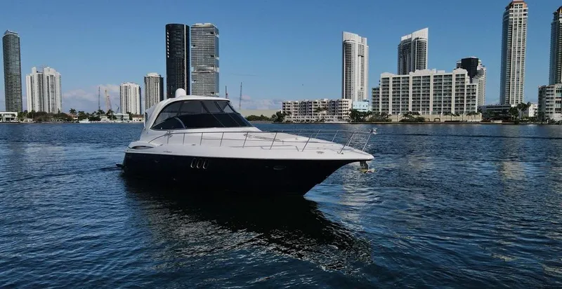  Yacht Photos Pics 2009 Cruisers Yachts 460 Express on water with city skyline backdrop.