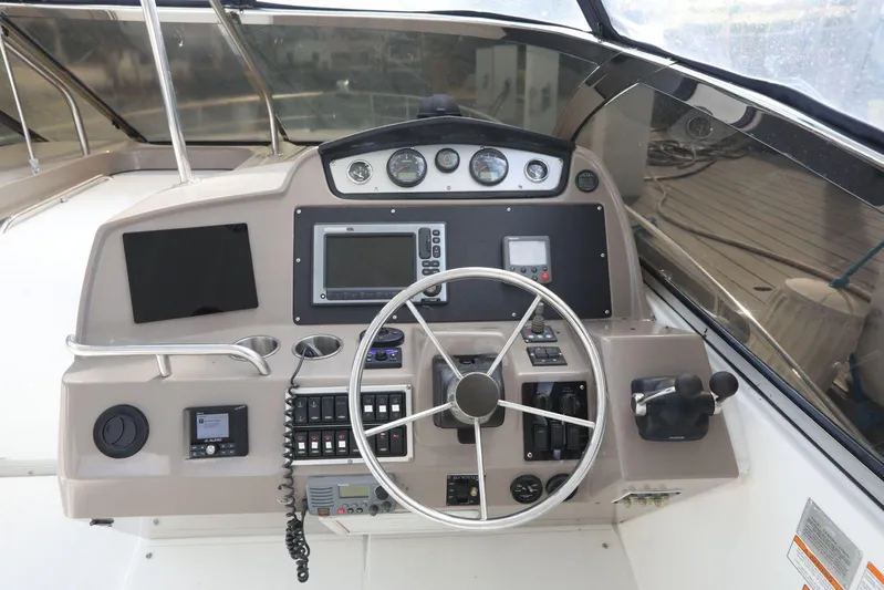  Yacht Photos Pics 2009 Cruisers Yachts 460 Express helm with steering wheel and navigation controls.