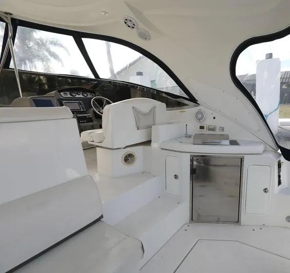  Yacht Photos Pics 2009 Cruisers Yachts 460 Express interior with helm, seating, and kitchenette.