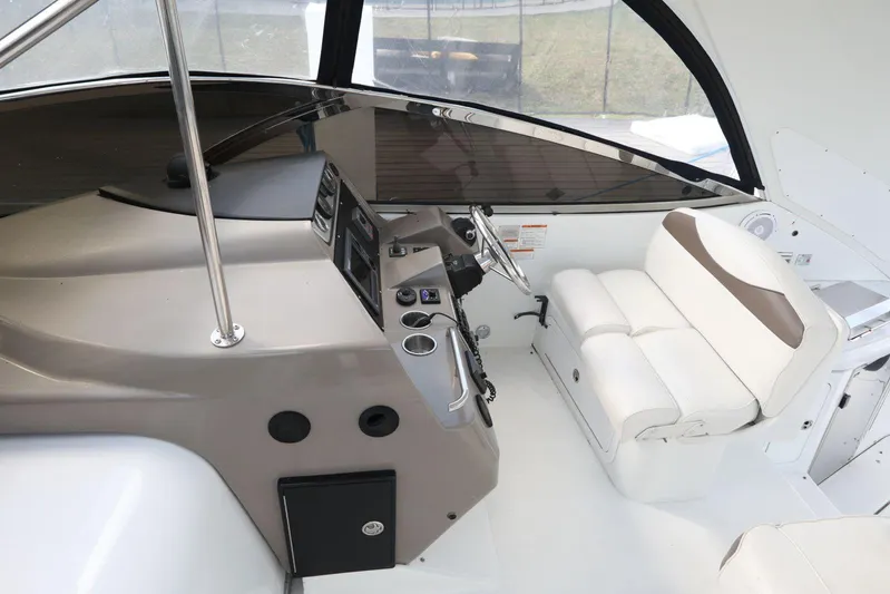  Yacht Photos Pics 2009 Cruisers Yachts 460 Express helm with white seating and modern controls.