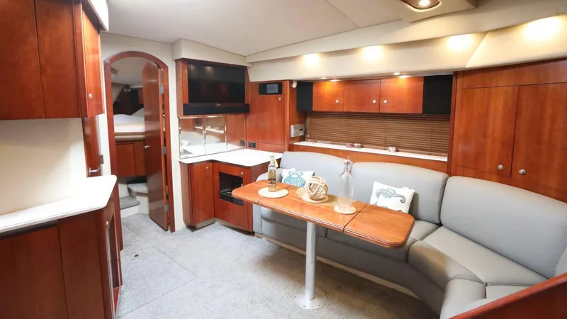  Yacht Photos Pics Luxurious interior of 2009 Cruisers Yachts 460 Express with elegant wood finishes and cozy seating.