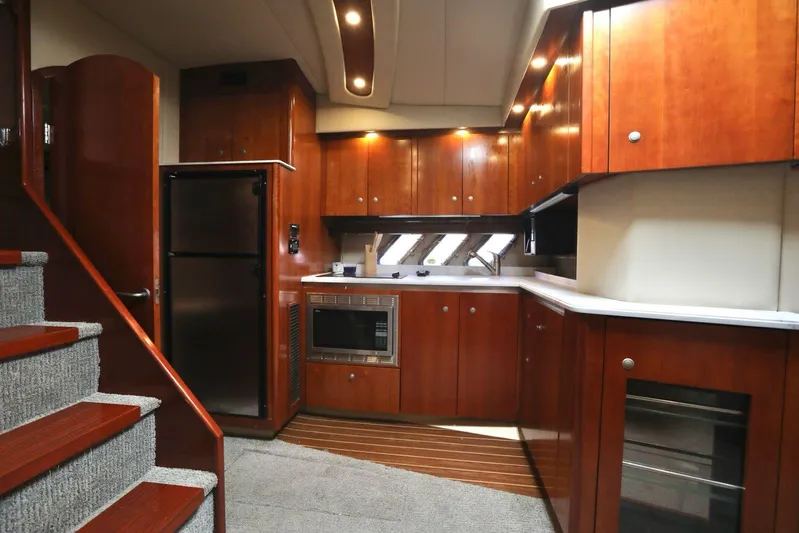  Yacht Photos Pics Luxurious 2009 Cruisers Yachts 460 Express kitchen with wood cabinetry and modern appliances.