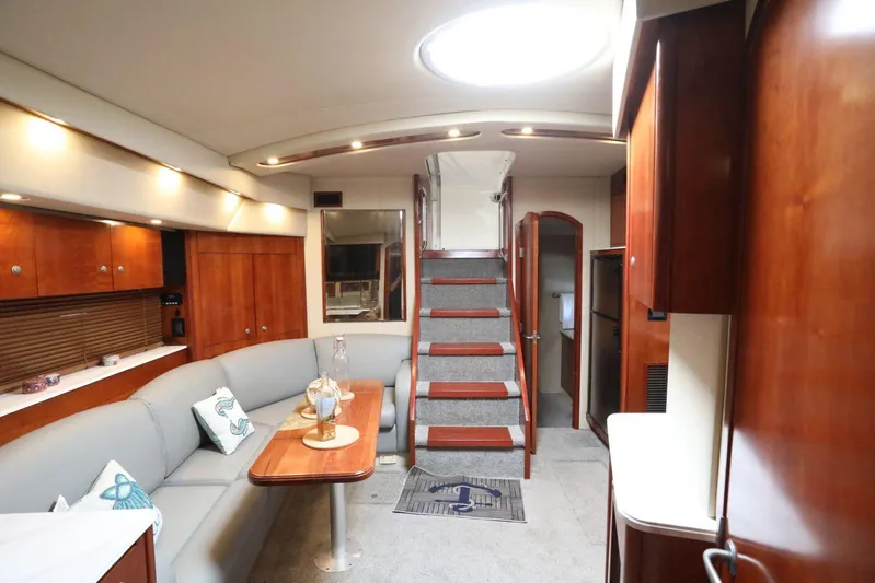  Yacht Photos Pics Luxurious interior of 2009 Cruisers Yachts 460 Express with elegant wood finishes and cozy seating.