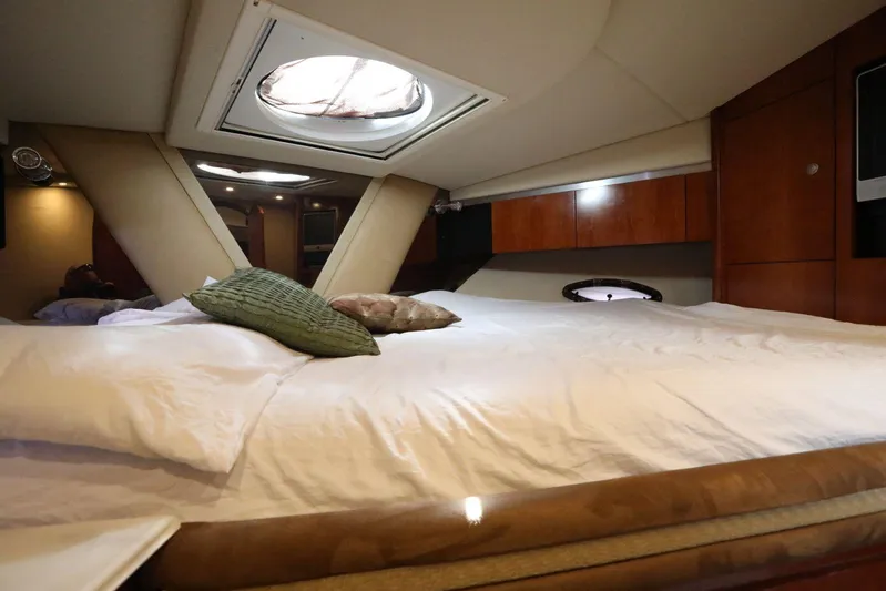  Yacht Photos Pics Luxurious bedroom interior of 2009 Cruisers Yachts 460 Express with skylight and plush bedding.