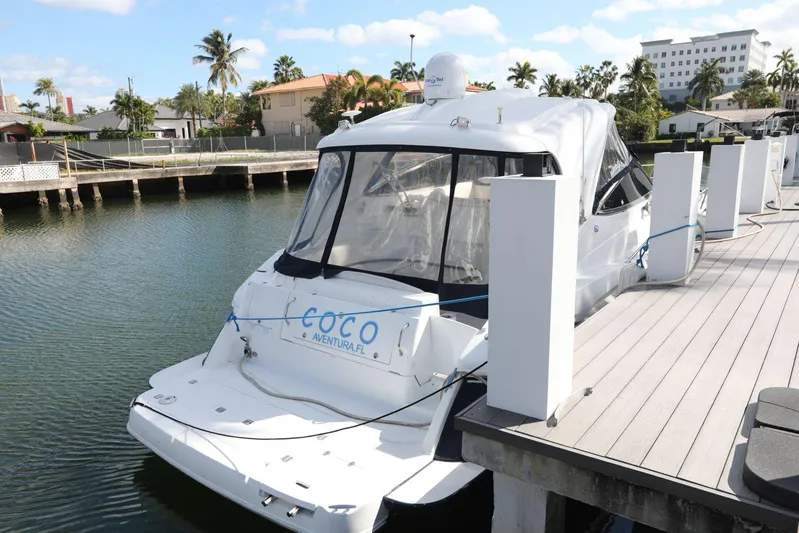  Yacht Photos Pics 2009 Cruisers Yachts 460 Express docked in a sunny marina setting.