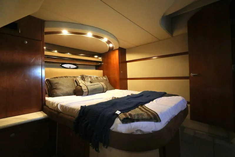  Yacht Photos Pics Luxurious cabin interior of 2009 Cruisers Yachts 460 Express with cozy bed and elegant lighting.