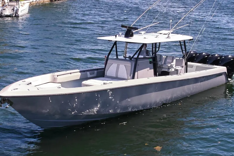  Yacht Photos Pics 2022 Contender 44 ST boat on water, featuring sleek design and multiple outboard engines.