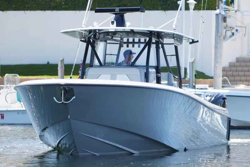  Yacht Photos Pics 2022 Contender 44 ST boat cruising in a marina, sleek design, calm waters.