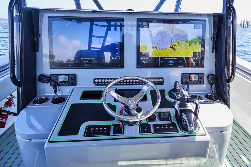  Yacht Photos Pics 2022 Contender 44 ST boat dashboard with dual Garmin displays and modern controls.