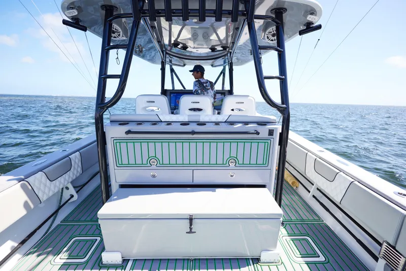  Yacht Photos Pics 2022 Contender 44 ST boat interior with captain at helm on open water.