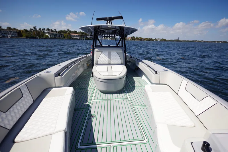  Yacht Photos Pics 2022 Contender 44 ST boat with spacious seating on open water.